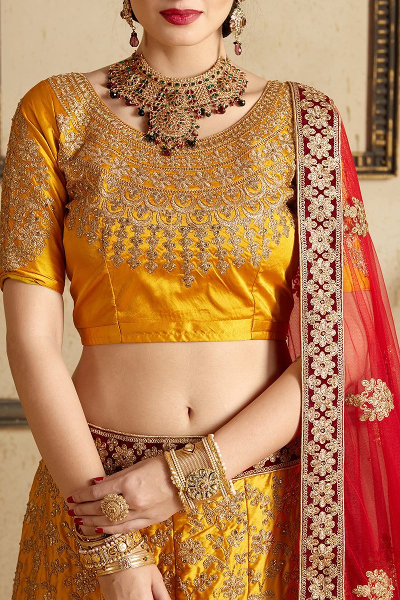 Brown-Red-Yellow colored lehenga set with artistic embroidery of stones stitched in gold thread