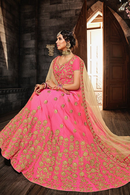 Pink colored lehenga set with lush and well-crafted artwork