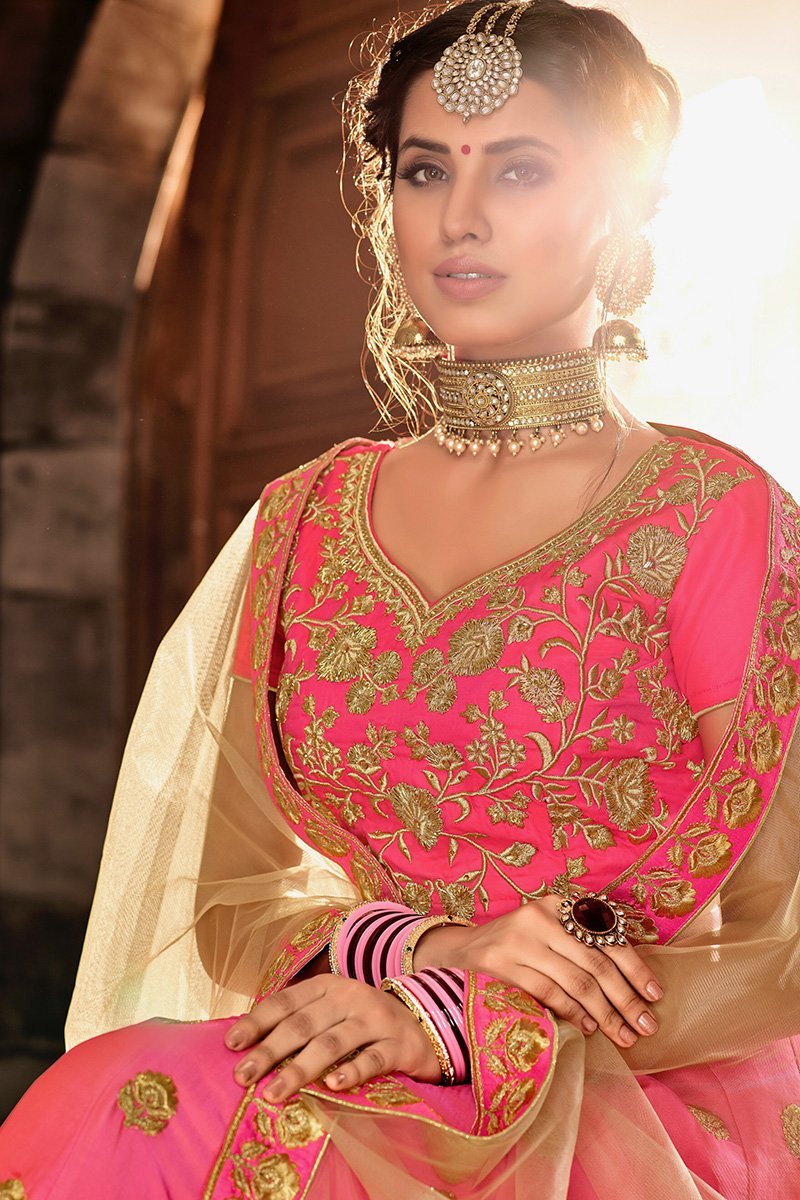 Pink colored lehenga set with lush and well-crafted artwork