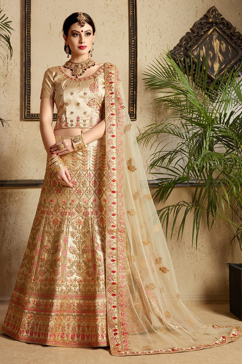 Beige color lehenga set with craftily designed artwork