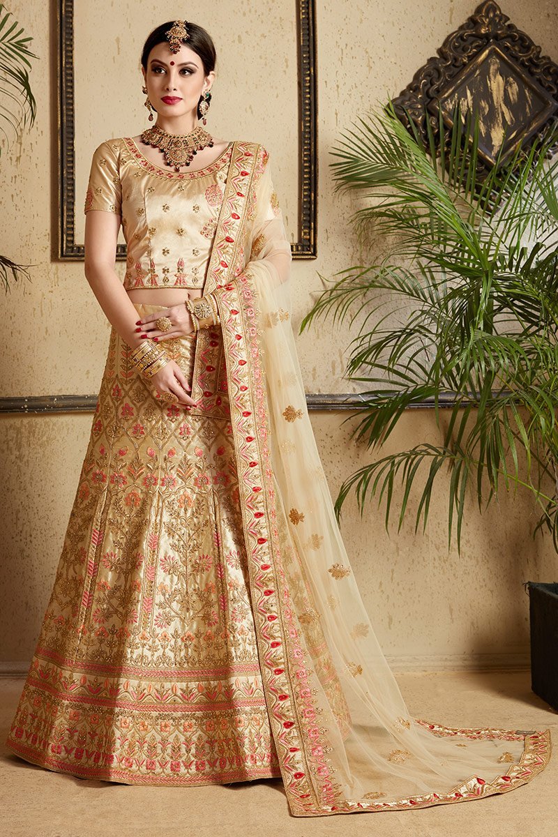 Beige color lehenga set with craftily designed artwork