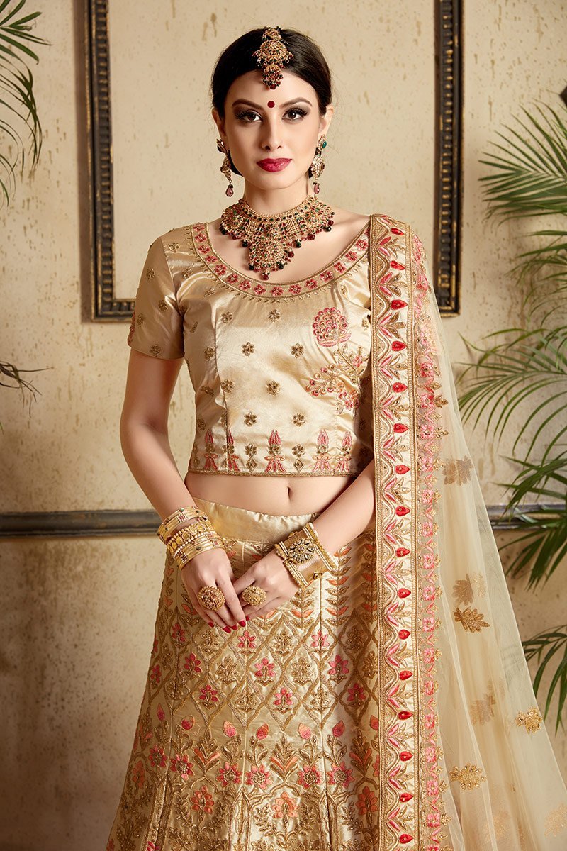 Beige color lehenga set with craftily designed artwork