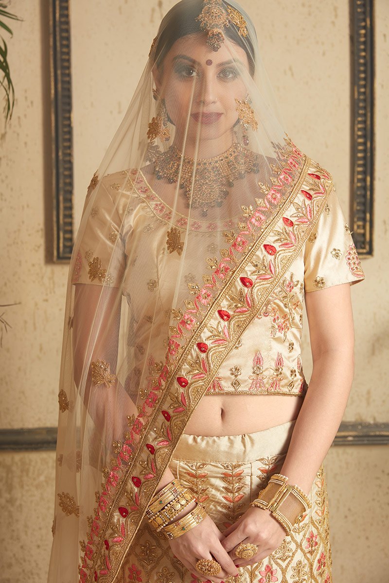 Beige color lehenga set with craftily designed artwork