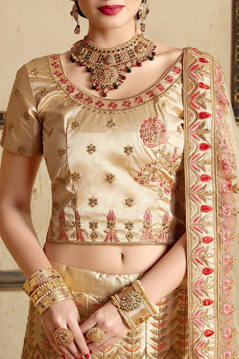 Beige color lehenga set with craftily designed artwork