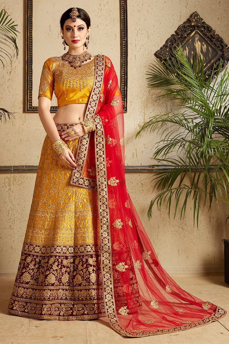 Brown-Red-Yellow colored lehenga set with artistic embroidery of stones stitched in gold thread