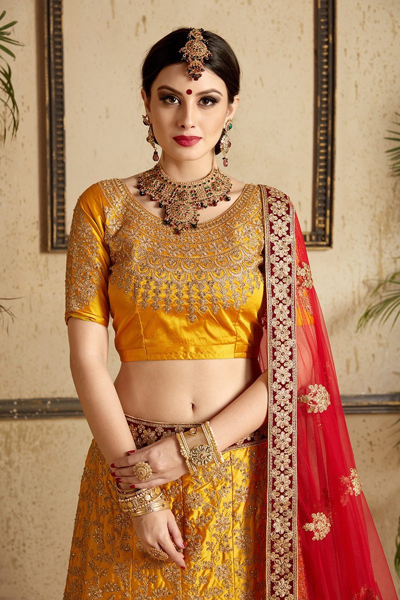 Brown-Red-Yellow colored lehenga set with artistic embroidery of stones stitched in gold thread