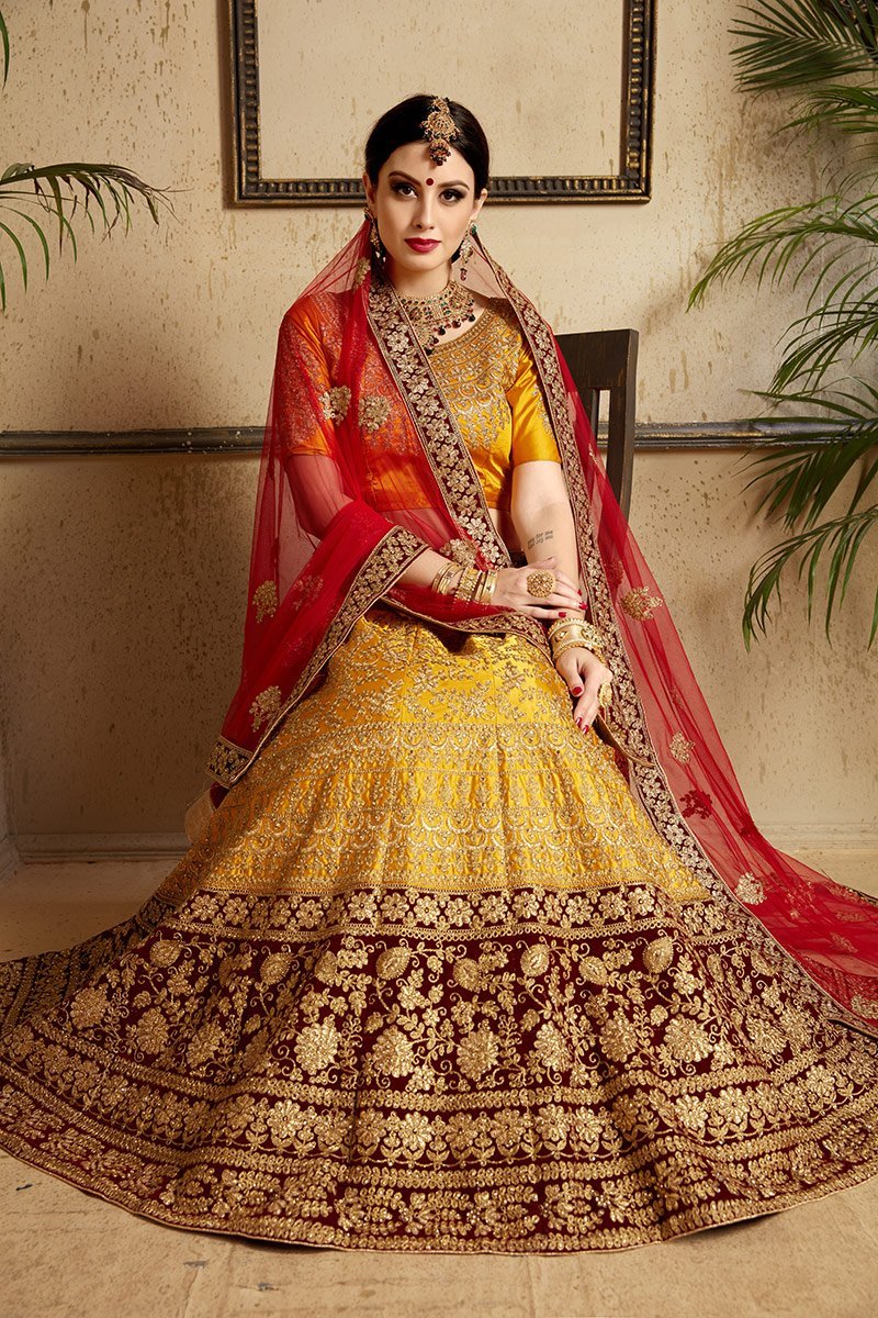 Brown-Red-Yellow colored lehenga set with artistic embroidery of stones stitched in gold thread